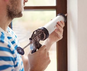 Man Caulking Window Picture