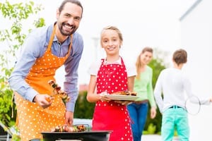 Family Barbecuing Outdoors Picture