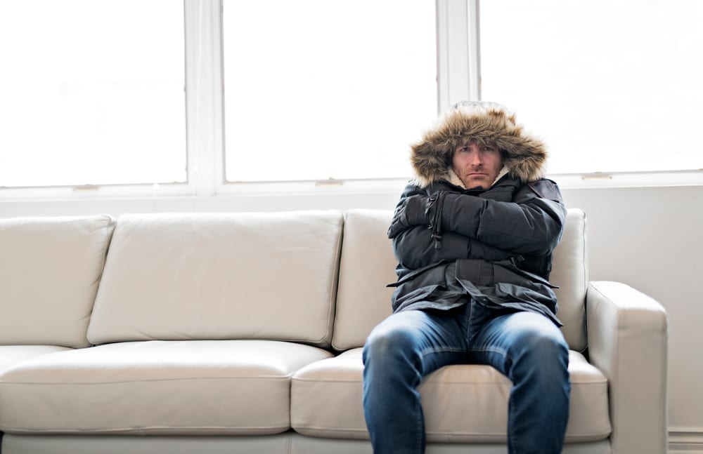 cold man sitting in sofa