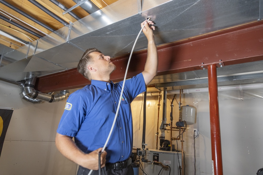 employee completing duct work
